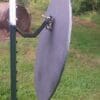 Hang Fast STANDARD T Post hanger with 24 inch round AR500 steel plate hanging on a short chain section