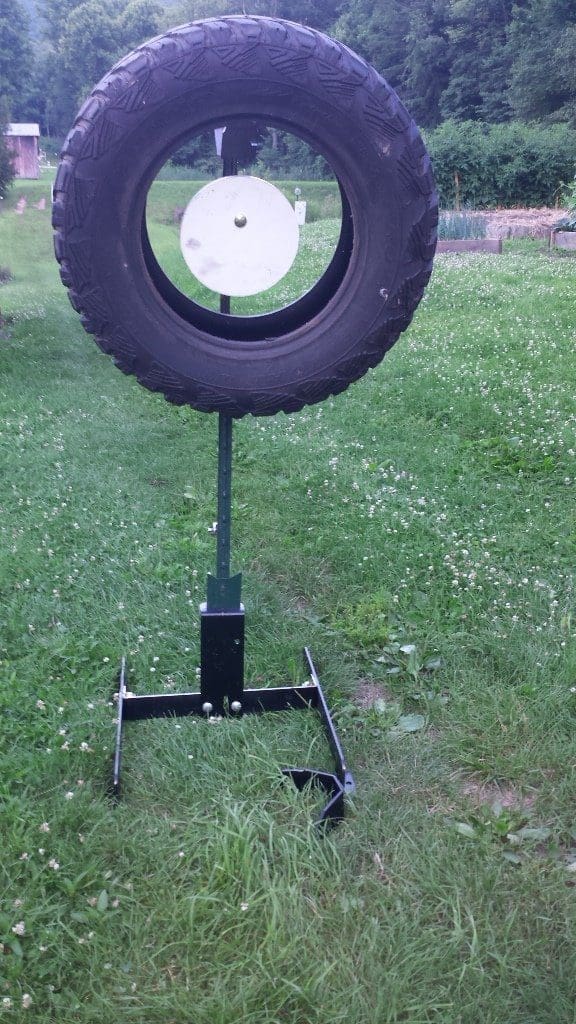 Hang Fast Tire Target System with 12 inch AR500 steel plate inside a truck tire mounted on an All Terrain T Post stand