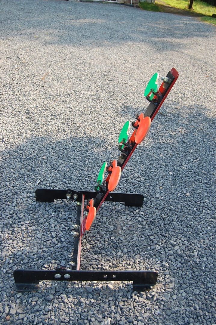 Hang Fast 6 plate rimfire dueling tree AR 500 side view mounted on all-terrain adjustable base. Fully armored.
